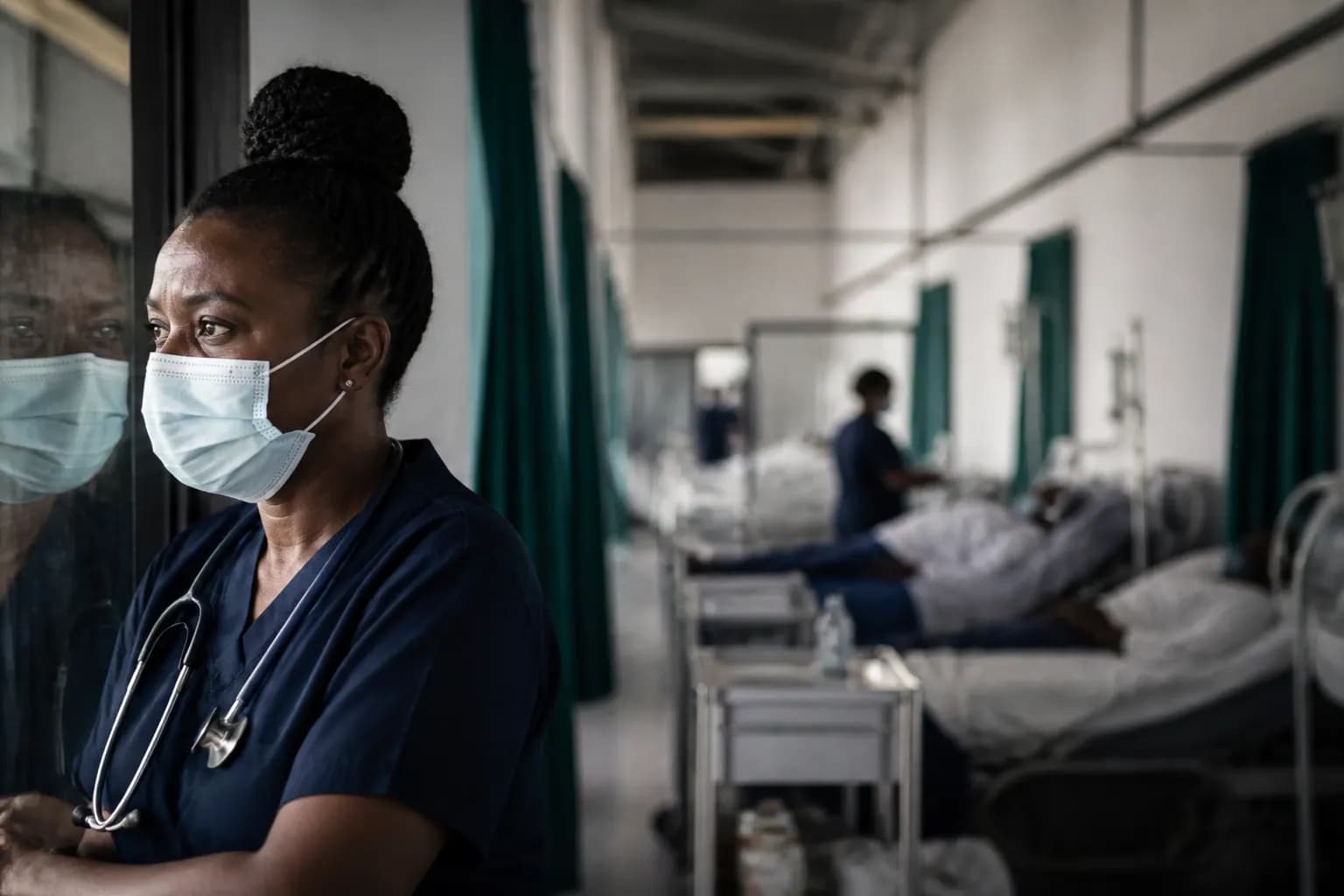A hospital corridor with equipment in soft focus, symbolising health-system capacity.