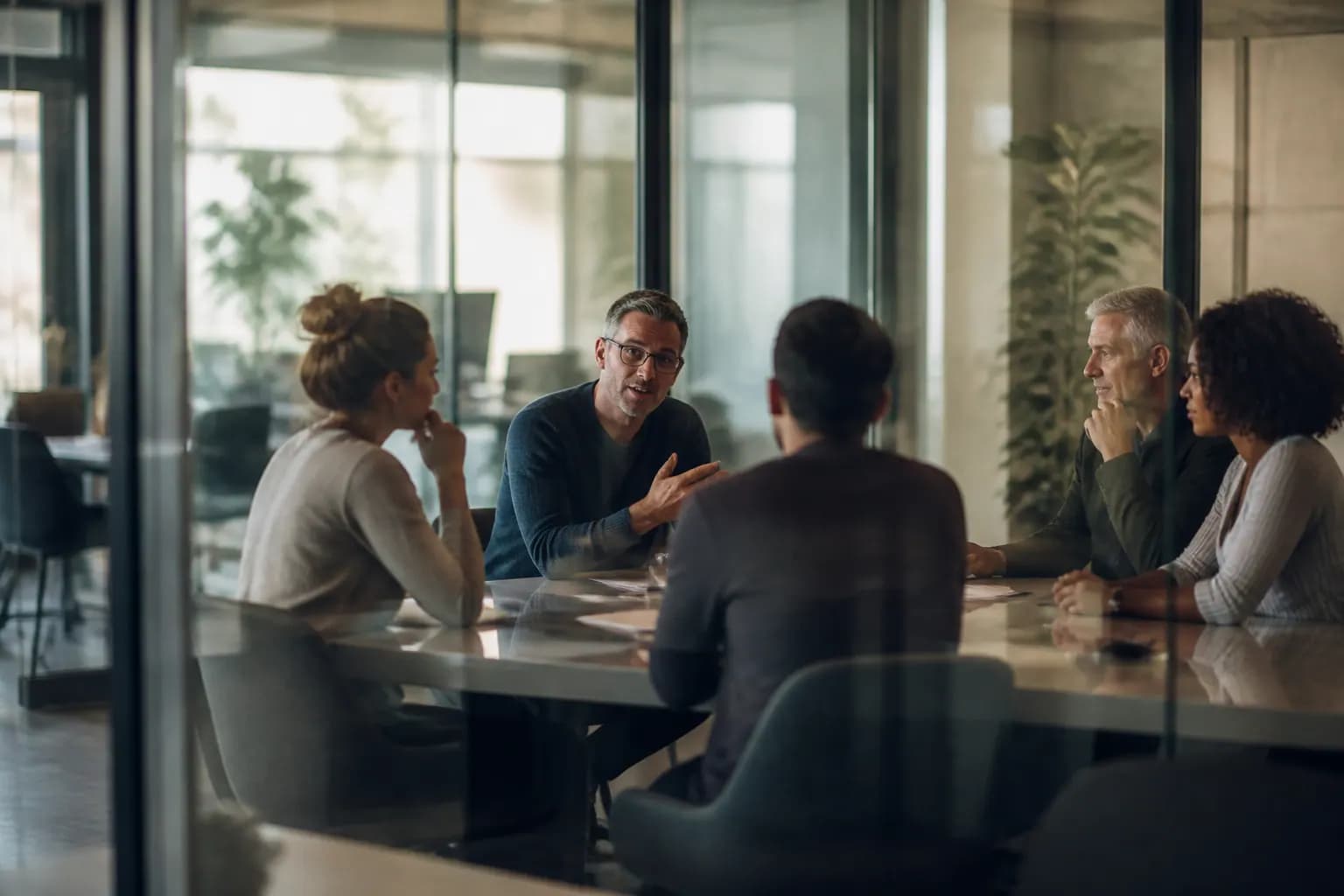 Focus group participants discussing brand concept boards around a table.